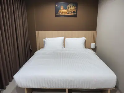 a bedroom with a large bed with white sheets at Sleepwell@naiyang in Nai Yang Beach