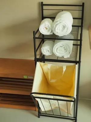 a towel rack with white towels on it at Sleepwell@naiyang in Nai Yang Beach