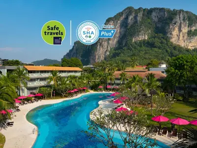 a resort with a beach and a mountain in the background at Aonang Villa Resort l Lifestyle Beachfront Resort in Ao Nang Beach