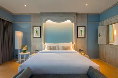 a bedroom with a large bed with blue walls at Aonang Villa Resort l Lifestyle Beachfront Resort in Ao Nang Beach