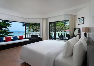 a bedroom with a white bed with a view of the ocean at Aonang Villa Resort l Lifestyle Beachfront Resort in Ao Nang Beach