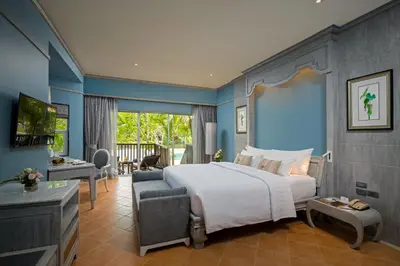 a bedroom with a large bed and a living room at Aonang Villa Resort l Lifestyle Beachfront Resort in Ao Nang Beach