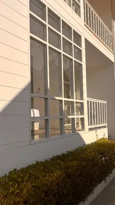 a white house with large windows on the side of it at PP Blue Sky Resort-SHA Plus in Phi Phi Don