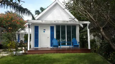 a small house with blue chairs on a porch at PP Blue Sky Resort-SHA Plus in Phi Phi Don