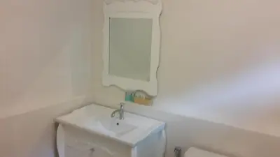 a white bathroom with a sink and a toilet at PP Blue Sky Resort-SHA Plus in Phi Phi Don