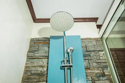 a microphone in a room with a stone wall at Phi Phi Andaman Beach Resort in Phi Phi Don
