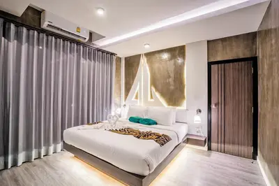 a bedroom with a large white bed and a window at Phi Phi Andaman Legacy Resort in Phi Phi Don