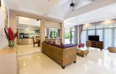a living room with a couch and a television at Villa Raeya in Ao Nang Beach