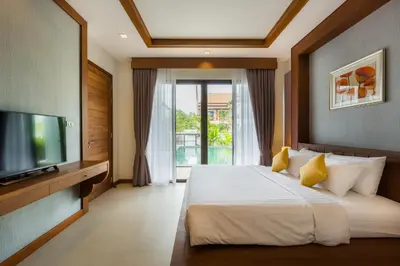 a bedroom with a large bed and a television at Villa Palavee (B3) in Ao Nang Beach