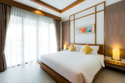 a bedroom with a large bed and a large window at Villa Palavee (B3) in Ao Nang Beach