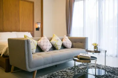 a living room with a couch with pillows and a bed at Villa Palavee (B3) in Ao Nang Beach
