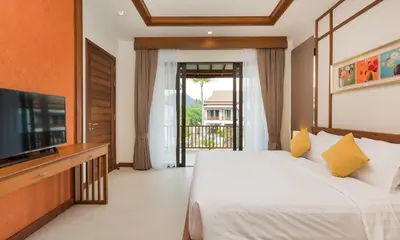 a bedroom with a bed and a flat screen tv at Villa Palavee (B3) in Ao Nang Beach