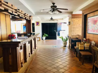 a restaurant with a bar and tables and chairs at Jiraporn Hill Resort in Patong Beach