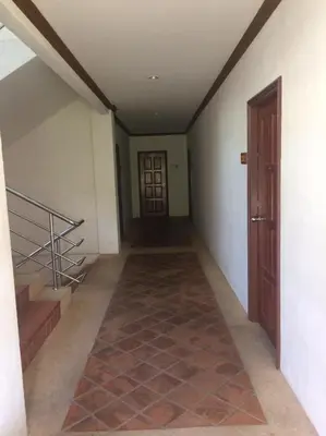 an empty hallway with stairs and a door at Jiraporn Hill Resort in Patong Beach