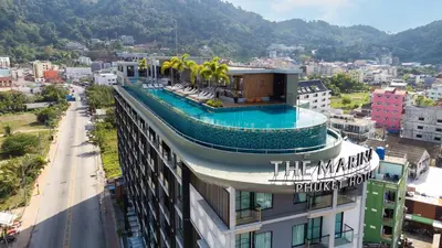 a building with a swimming pool on top of it at The Marina Phuket Hotel in Patong Beach