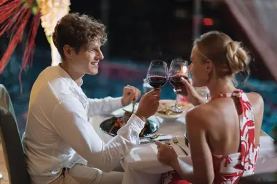 two people sitting at a table drinking wine at The Marina Phuket Hotel in Patong Beach
