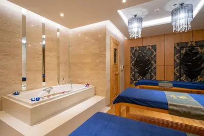 a bathroom with a tub and a bed at The Marina Phuket Hotel in Patong Beach
