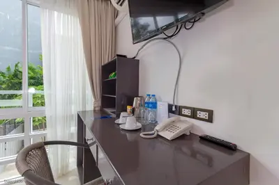 a desk in a room with a telephone and a window at Modern Living Residence in Patong Beach
