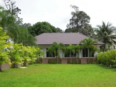 a house with a green lawn in front of it at PS Hill Resort Phuket Patong - SHA Plus in Patong Beach