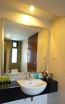 a bathroom with a sink and a large mirror at PS Hill Resort Phuket Patong - SHA Plus in Patong Beach