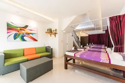 a room with a bed and a couch at Vacation Time House in Nai Yang Beach