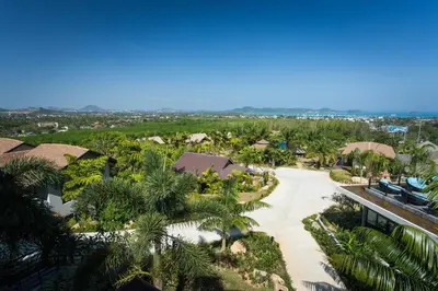 an aerial view of a resort with palm trees at Chalong Chalet Resort in Chalong