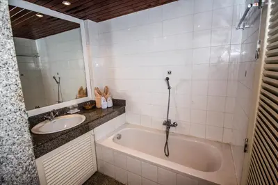 a bathroom with a tub and a sink at Bougainvillea Terrace House in Kata Beach