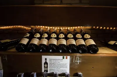 a bunch of bottles of wine sitting on a shelf at Bougainvillea Terrace House in Kata Beach