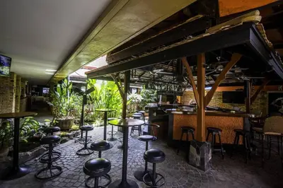 a bar with a bunch of stools in a room at Bougainvillea Terrace House in Kata Beach