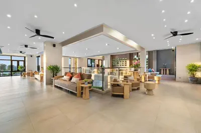 a lobby of a hotel with couches and chairs at Hotel IKON Phuket - SHA Extra Plus in Karon Beach