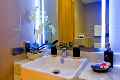 a bathroom with a sink and a large mirror at Oceanstone by Holy Cow, 2-BR, 60 m2, tree view in Bang Tao Beach