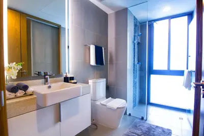 a bathroom with a sink and a toilet and a mirror at Oceanstone by Holy Cow, 2-BR, 60 m2, tree view in Bang Tao Beach