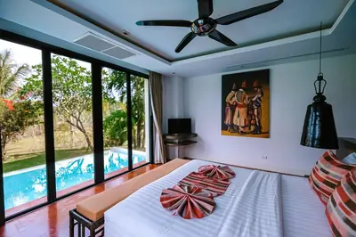 a bedroom with a bed with a ceiling fan at VILLA Chacha VILLA Coco RESORT APOLLONIA in Ko Yao Noi
