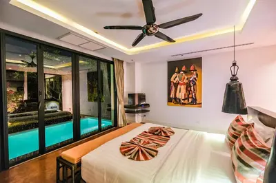 a bedroom with a bed and a ceiling fan at VILLA Chacha VILLA Coco RESORT APOLLONIA in Ko Yao Noi