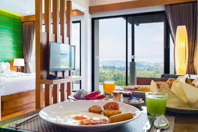 a breakfast table in a hotel room with a plate of food at Andakiri Pool Villa Panoramic Sea View in Ao Nang Beach