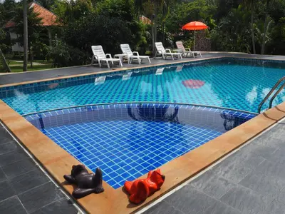 a swimming pool with a mermaid figurines in the water at Supsangdao Resort in Ao Nang Beach