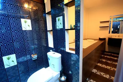 a bathroom with a toilet and a blue tiled wall at Supsangdao Resort in Ao Nang Beach