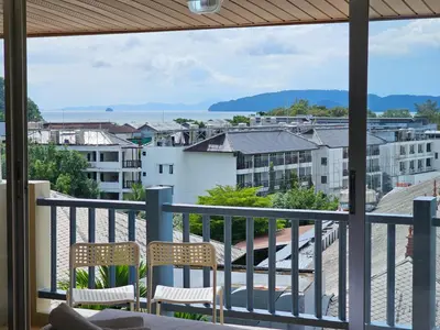 a balcony with chairs and a view of a city at Ben's House in Ao Nang Beach