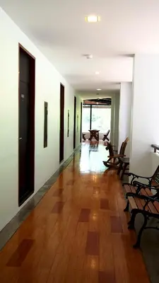 an empty room with chairs and a wooden floor at Phranang Place- SHA Extra in Ao Nang Beach