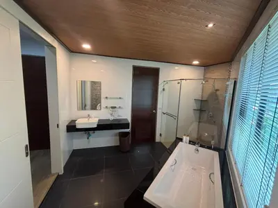 a bathroom with a shower and a sink and a tub at Phranang Place- SHA Extra in Ao Nang Beach