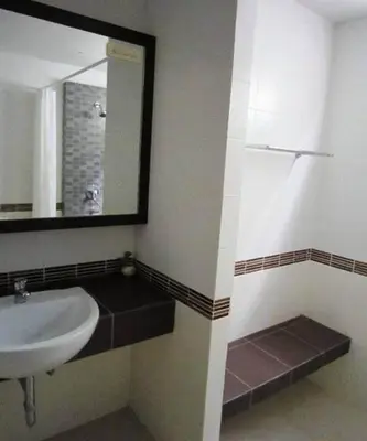 a bathroom with a sink and a mirror at J Hotel in Ao Nang Beach