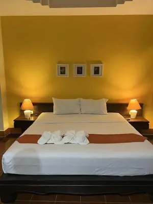 a bedroom with a large bed with two towels on it at J Hotel in Ao Nang Beach