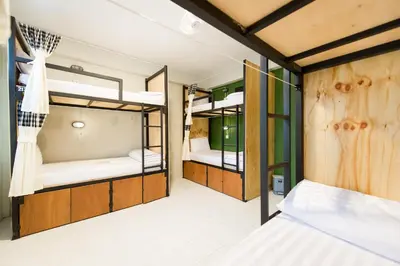 a room with three bunk beds in it at The Neighbors Hostel in Phuket Town
