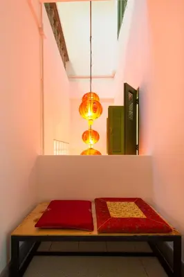 a room with a table with two blankets on it at The Neighbors Hostel in Phuket Town