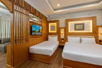 two beds in a room with wooden walls at Naiyang Park Resort - SHA Extra Plus in Nai Yang Beach