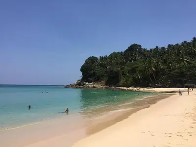 a group of people swimming in the water on a beach at The Aristo by Holy Cow, 4-BR loft, 150 m2, pool view in Surin Beach