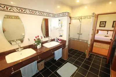 a bathroom with two sinks and a large mirror at Villa Pimlada in Nai Harn Beach