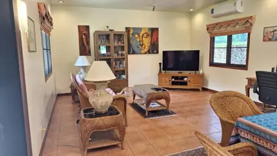 a living room filled with furniture and a tv at Villa Pimlada in Nai Harn Beach
