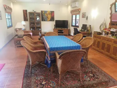 a dining room with a table and chairs at Villa Pimlada in Nai Harn Beach