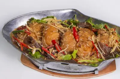 a metal pan filled with food on a table at PS Hotel Phuket Patong - SHA Plus in Patong Beach